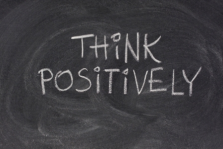 think positively slogan on blackboard
